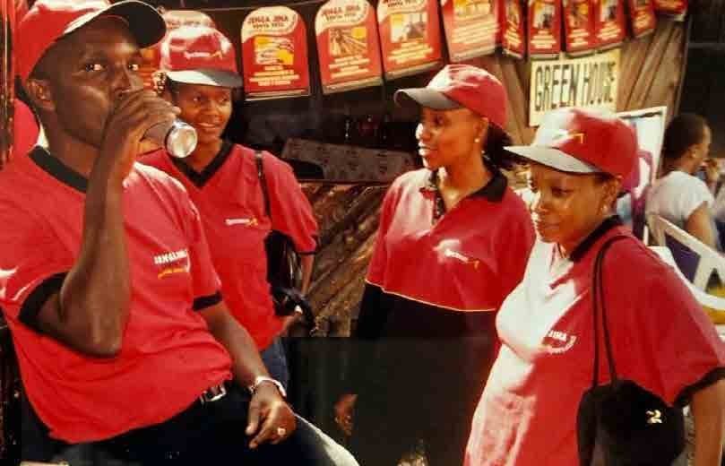 British American Tobacco field-work moment with people in red uniforms.