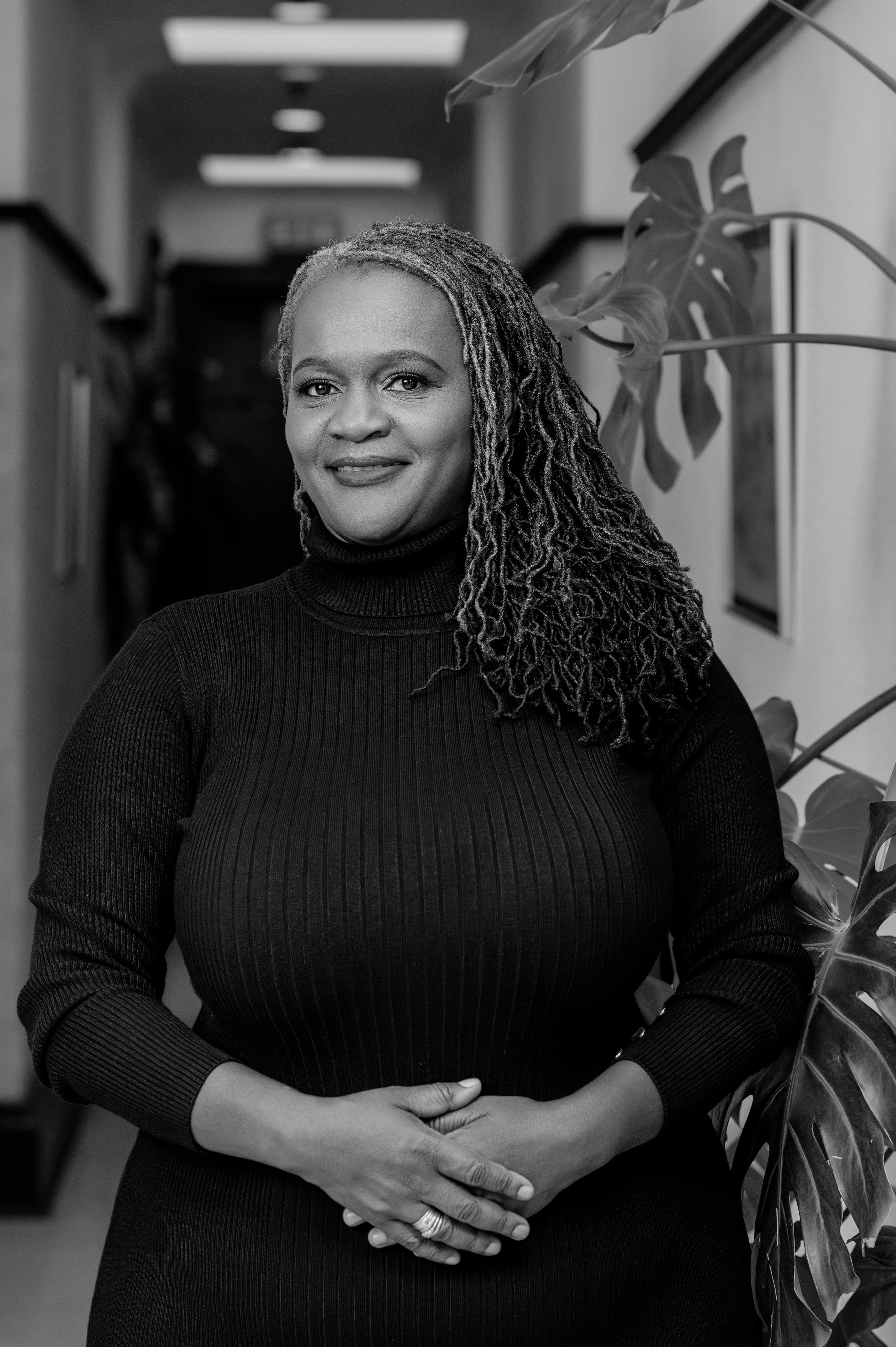 Clara Mlambo in a black-and-white office portrait.